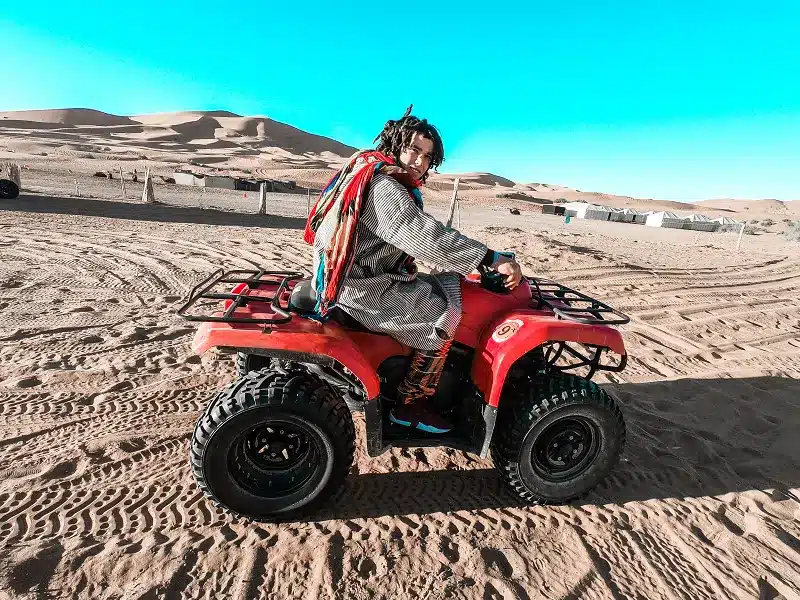 a person on a quad bike in the desert with our top Morocco Activities