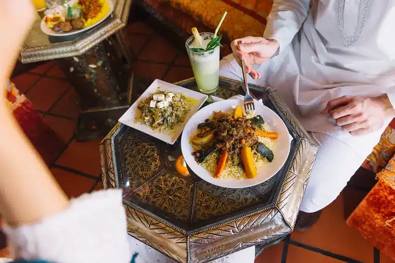 man eating moroccan food in a Moroccan Riad