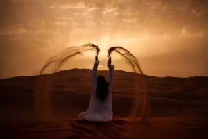A Woman Tourist Setting in the Sand Dunes While Having Morocco Desert Tours