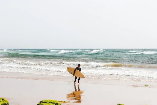 Young Boy in Agadir Beach Safely Surfing 