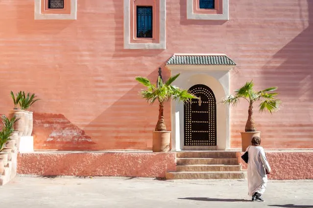 A Local Moroccan Woman infront of Moroccan House