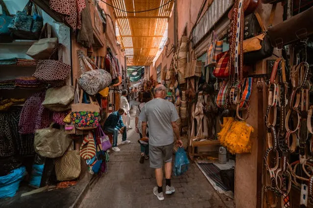 Is Marrakech safe for tourists, Americans and solo women travelers? YEs, a Tourist is Walinkg safely inside the bustlink Souks of Marrakech