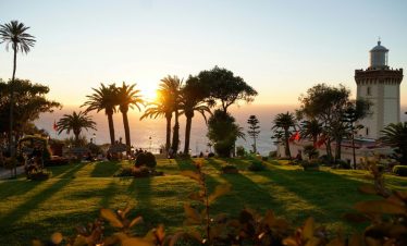 Palm-lined garden overlooking the Atlantic at sunset on a private 13-day Morocco tour from Tangier