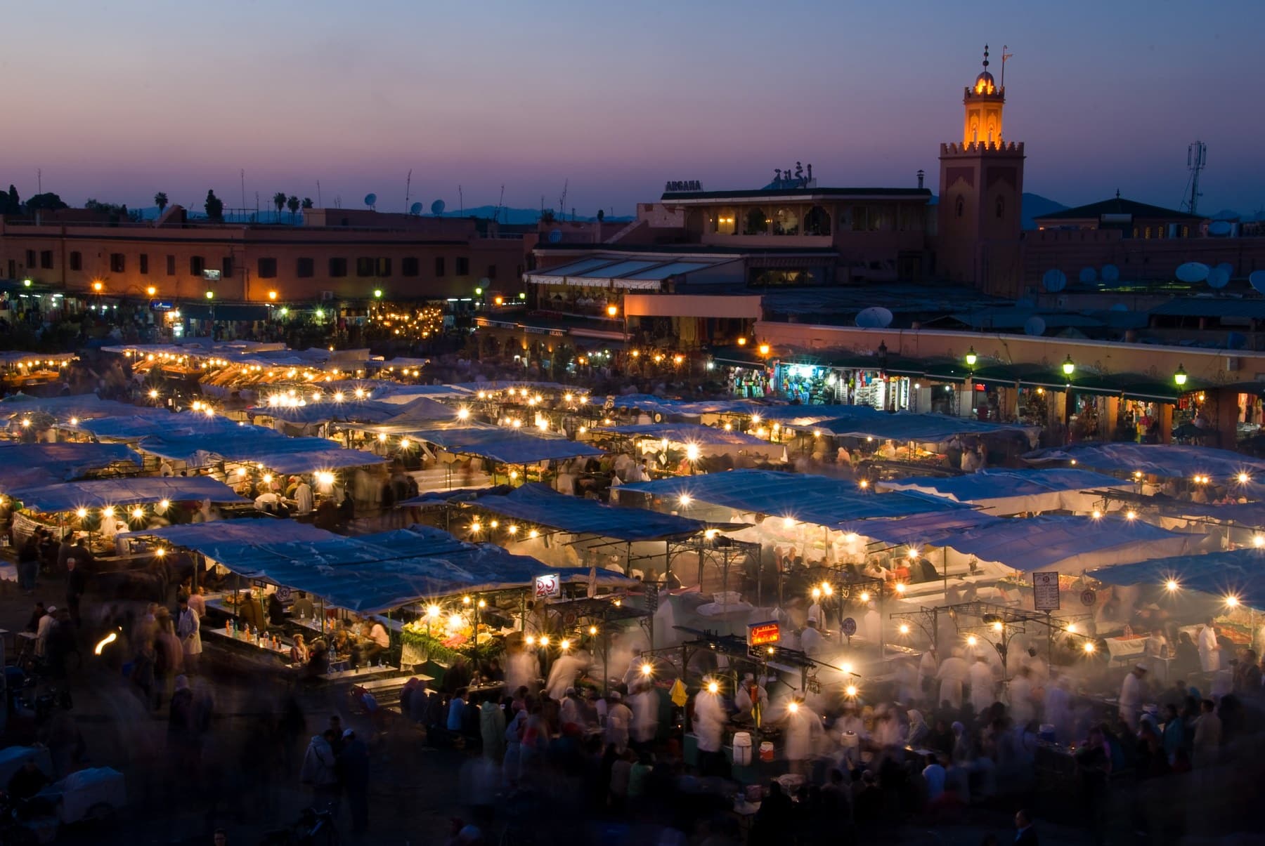 Real photograph of Jemaa el-Fna food stalls at dusk in Marrakech