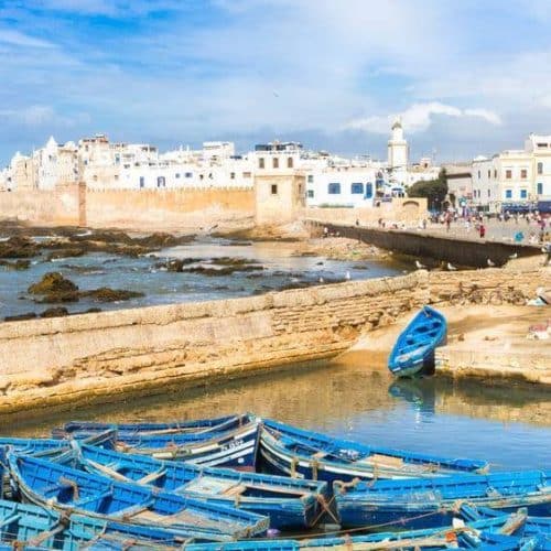 Blue fishing boats at Essaouira harbor on a private 15-day Morocco tour from Casablanca